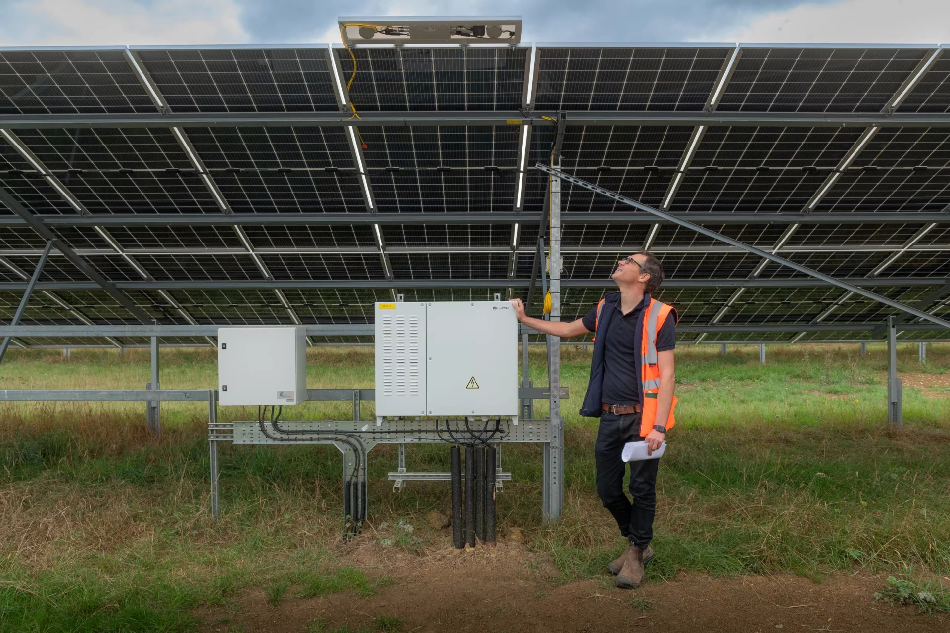 HCC engineer beside the solar array and inverter at Ray Valley Solar